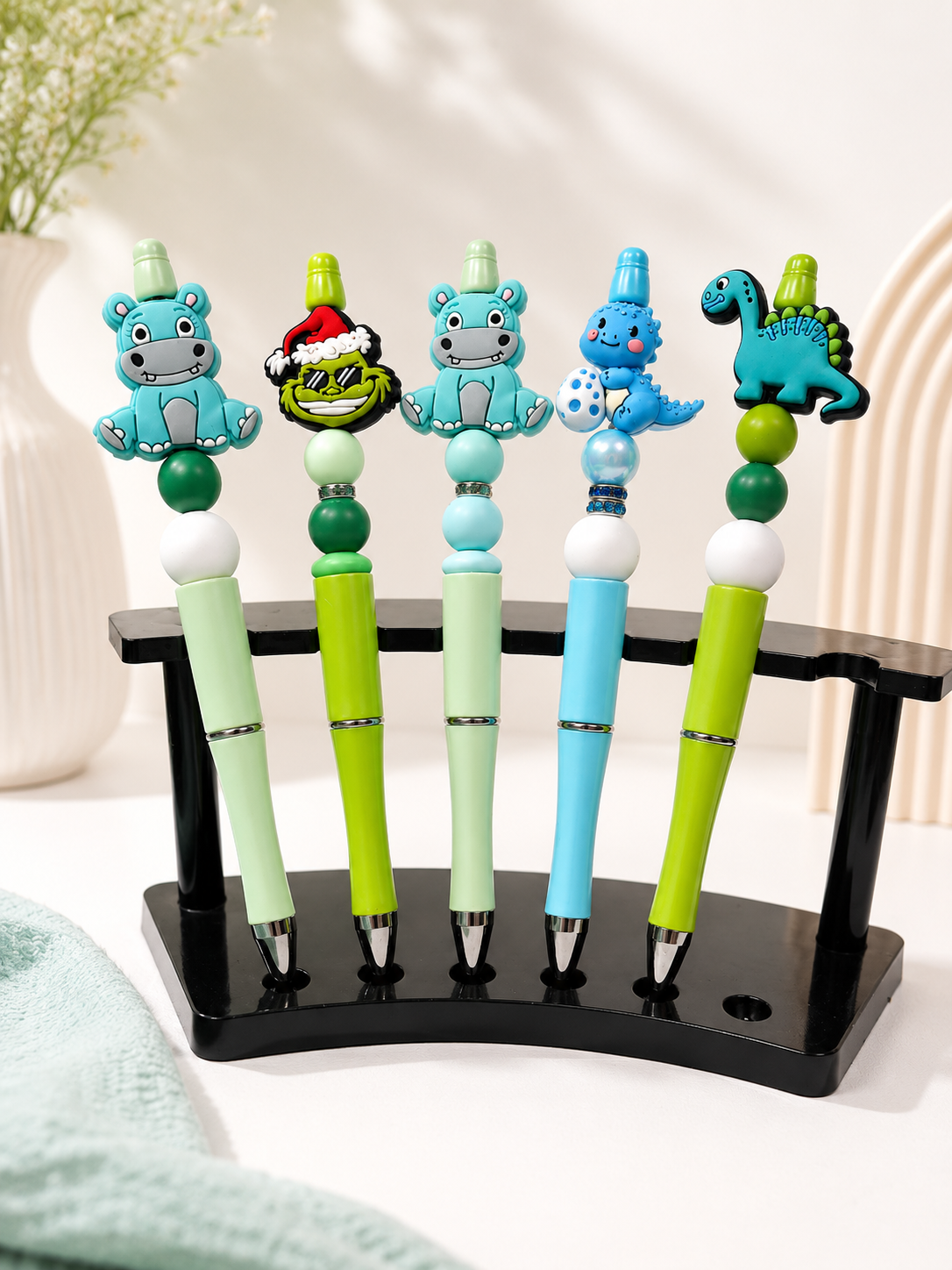 Custom beaded pens with green dinosaur and hippo charm toppers